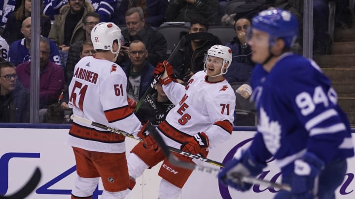 Feb 22, 2020; Toronto, Ontario, CAN; Carolina Hurricanes forward Lucas Wallmark (71) celebrates his goal against the Toronto Maple Leafs with Carolina Hurricanes defenseman Jake Gardiner (51) during the second period at Scotiabank Arena. Mandatory Credit: John E. Sokolowski-USA TODAY Sports