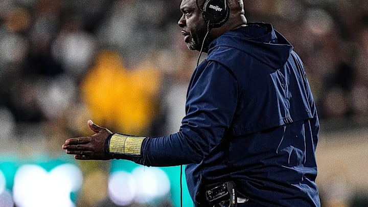 Michigan running backs coach Tony Alford talks to players before a play against Michigan State during the first half at Spartan Stadium in East Lansing on Saturday, October 25, 2025.