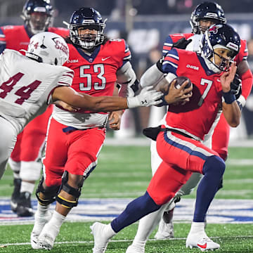 Dec 1, 2023; Lynchburg, VA, USA; Liberty Flames quarterback Kaidon Salter (7) runs the ball while New Mexico State Aggies linebacker Keyshaun Elliott (44) reaches out to try to tackle him during the third quarter at Williams Stadium. Mandatory Credit: Brian Bishop-Imagn Images