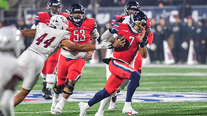 Dec 1, 2023; Lynchburg, VA, USA; Liberty Flames quarterback Kaidon Salter (7) runs the ball while New Mexico State Aggies linebacker Keyshaun Elliott (44) reaches out to try to tackle him during the third quarter at Williams Stadium. Mandatory Credit: Brian Bishop-Imagn Images