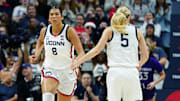 UConn Huskies center Jana El Alfy and guard Paige Bueckers react after a play against the Holy Cross Crusaders.