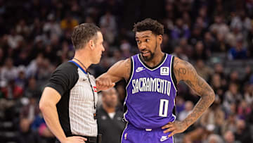 Dec 21, 2024; Sacramento, California, USA; Sacramento Kings guard Malik Monk (0) discusses a call with referee Gediminas Petraitis (50) during the third quarter of the game against the Los Angeles Lakers at Golden 1 Center. Mandatory Credit: Ed Szczepanski-Imagn Images