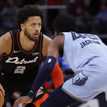 Apr 1, 2024; Detroit, Michigan, USA;  Detroit Pistons guard Cade Cunningham (2) dribbles defended by Memphis Grizzlies forward GG Jackson (45) in the first half at Little Caesars Arena. Mandatory Credit: Rick Osentoski-USA TODAY Sports