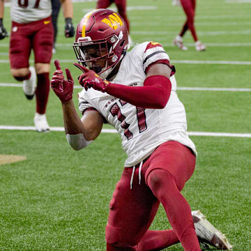 Dec 15, 2024; New Orleans, Louisiana, USA;  Washington Commanders wide receiver Terry McLaurin (17) celebrates a touchdown against the New Orleans Saints cornerback Kool-Aid McKinstry (14) during the first half at Caesars Superdome. Mandatory Credit: Matthew Hinton-Imagn Images