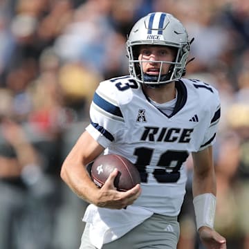 Sep 21, 2024; West Point, New York, USA; Rice Owls quarterback E.J. Warner (13) runs with the ball against the Army Black Knights during the first half at Michie Stadium. Mandatory Credit: Danny Wild-Imagn Images