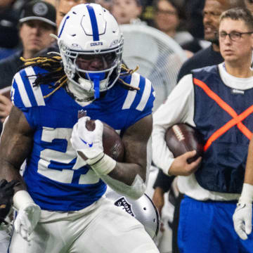 Dec 31, 2023; Indianapolis, Indiana, USA; Indianapolis Colts running back Trey Sermon (27) runs the ball while Las Vegas Raiders safety Marcus Epps (1) and safety Tre'von Moehrig (25) defend  in the second half at Lucas Oil Stadium. Mandatory Credit: Trevor Ruszkowski-USA TODAY Sports