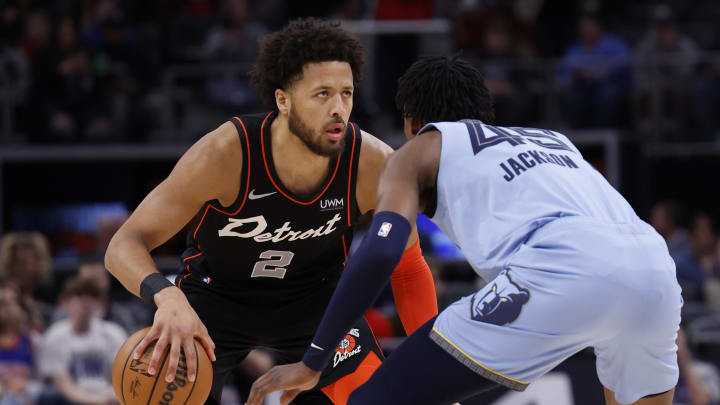 Apr 1, 2024; Detroit, Michigan, USA;  Detroit Pistons guard Cade Cunningham (2) dribbles defended by Memphis Grizzlies forward GG Jackson (45) in the first half at Little Caesars Arena. Mandatory Credit: Rick Osentoski-USA TODAY Sports