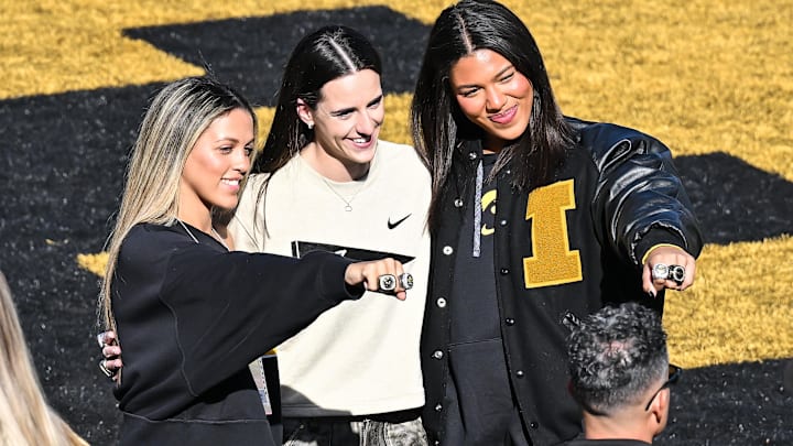 Gabbie Marshall, Caitlin Clark, and Jada Gyamfi react before being honored at the game between the Iowa Hawkeyes and the Northwestern Wildcats.