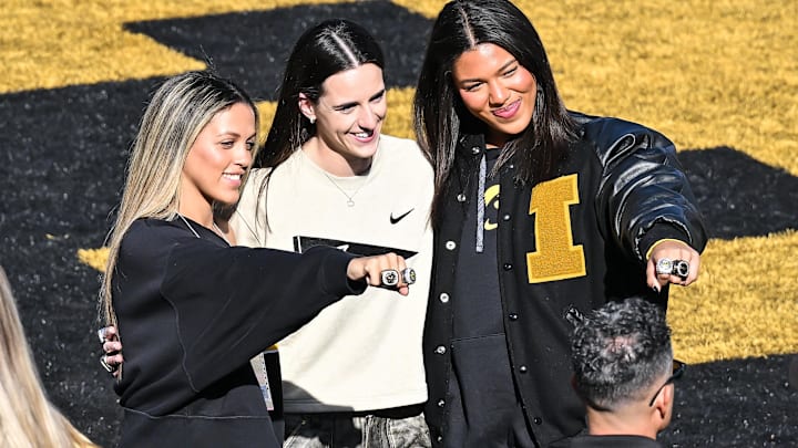 Gabbie Marshall, Caitlin Clark, and Jada Gyamfi react before being honored at the game between the Iowa Hawkeyes and the Northwestern Wildcats at Kinnick Stadium.