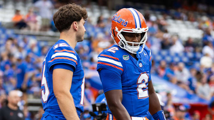 Florida Gators quarterbacks Graham Mertz and DJ Lagway talk before the game against the Samford Bulldogs at Ben Hill Griffin Stadium. 