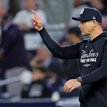 Oct 8, 2025; Bronx, New York, USA; New York Yankees manager Aaron Boone signals to the bullpen during the seventh inning against the Toronto Blue Jays during game four of the ALDS round for the 2025 MLB playoffs at Yankee Stadium. Mandatory Credit: Brad Penner-Imagn Images