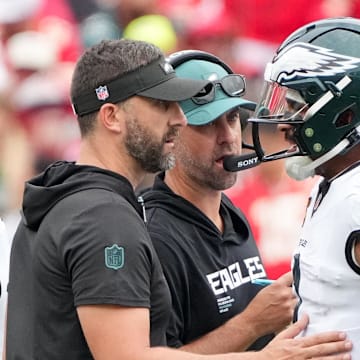 Sep 14, 2025; Kansas City, Missouri, USA; Philadelphia Eagles head coach Nick Sirianni and offenisve coordinator Kevin Patullo speak with Philadelphia Eagles quarterback Jalen Hurts (1) during the second quarter of the game against the Kansas City Chiefs at GEHA Field at Arrowhead Stadium. Mandatory Credit: Denny Medley-Imagn Images