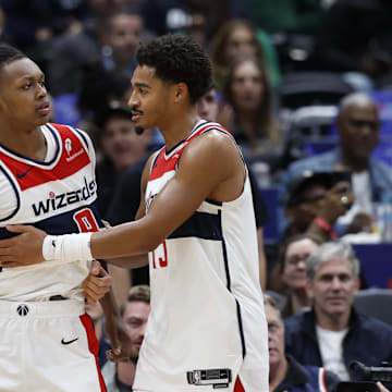 Oct 30, 2024; Washington, District of Columbia, USA; Washington Wizards guard Bub Carrington (8) is restrained by Wizards guard Jordan Poole (13) after being hard fouled by Atlanta Hawks guard Garrison Mathews (not pictured) in the first half at Capital One Arena. Mandatory Credit: Geoff Burke-Imagn Images