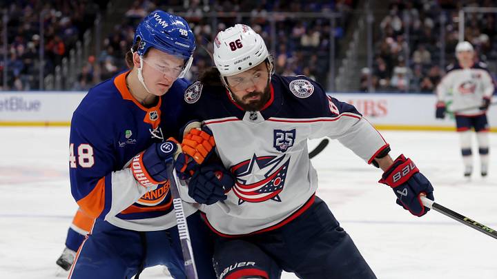Mar 22, 2026; Elmont, New York, USA; New York Islanders defenseman Matthew Schaefer (48) fights for position against Columbus Blue Jackets right wing Kirill Marchenko (86) during the first period at UBS Arena. Mandatory Credit: Brad Penner-Imagn Images