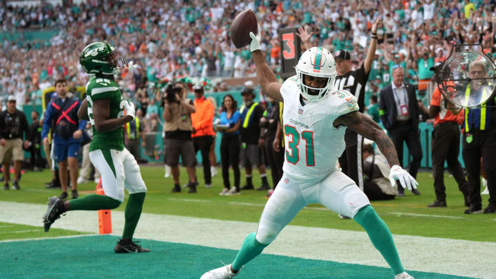 Miami Dolphins running back Raheem Mostert (31) spikes the ball after scoring a touchdown past New York Jets safety Tony Adams (22) during the first half of an NFL game at Hard Rock Stadium in Miami Gardens last season.