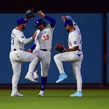 Jul 21, 2025; Los Angeles, California, USA; Los Angeles Dodgers left fielder Michael Conforto (23) outfielder James Outman (33) and center fielder Andy Pages (44) celebrate the victory against the Minnesota Twins at Dodger Stadium. Mandatory Credit: Gary A. Vasquez-Imagn Images