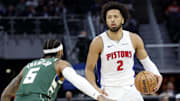 Oct 6, 2024; Detroit, Michigan, USA;  Detroit Pistons guard Cade Cunningham (2) dribbles defended by Milwaukee Bucks guard Gary Trent Jr. (5) in the first half at Little Caesars Arena. Mandatory Credit: Rick Osentoski-Imagn Images