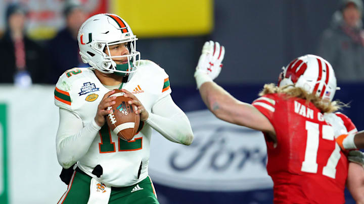 Dec 27, 2018; Bronx, NY, USA; Miami Hurricanes quarterback Malik Rosier (12) drops back to pass as Wisconsin Badgers linebacker Andrew Van Ginkel (17) pressures during the second quarter in the 2018 Pinstripe Bowl at Yankee Stadium. Mandatory Credit: Rich Barnes-Imagn Images