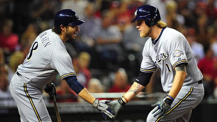 Oct 4, 2011; Phoenix, AZ, USA; Milwaukee Brewers outfielder Corey Hart (1) is congratulated by teammate  outfielder Ryan Braun (8) after hitting a solo home run against the Arizona Diamondbacks in the third inning in game three of the 2011 NLDS at Chase Field. Mandatory Credit: Mark J. Rebilas-Imagn Images