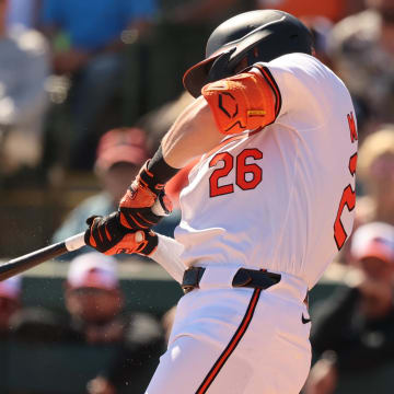 Feb 24, 2024; Sarasota, Florida, USA;  Baltimore Orioles center fielder Ryan McKenna (26) hits a ground ball into a force out during the fifth inning against the Boston Red Sox at Ed Smith Stadium