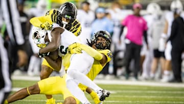 Oregon Ducks inside linebacker Jestin Jacobs, left, and defensive back Dakoda Fields, right, wrap up Michigan State Spartans wide receiver Nick Marsh as the Ducks host the Spartans Friday, Oct. 4, 2024 at Autzen Stadium in Eugene, Ore.
