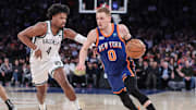 Mar 23, 2024; New York, New York, USA;  New York Knicks guard Donte DiVincenzo (0) looks to drive past Brooklyn Nets guard Dennis Smith Jr. (4) in the fourth quarter at Madison Square Garden. Mandatory Credit: Wendell Cruz-Imagn Images