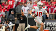 Ohio State Buckeyes quarterback Julian Sayin (10) runs past Purdue Boilermakers defensive lineman CJ Nunnally (91) during the NCAA football game at Ross-Ade Stadium in West Lafayette, Ind. on Nov. 8, 2025. Ohio State won 34-10.