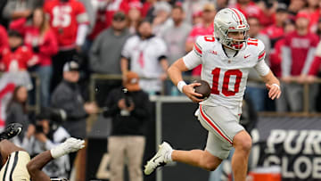 Ohio State Buckeyes quarterback Julian Sayin (10) runs past Purdue Boilermakers defensive lineman CJ Nunnally (91) during the NCAA football game at Ross-Ade Stadium in West Lafayette, Ind. on Nov. 8, 2025. Ohio State won 34-10.