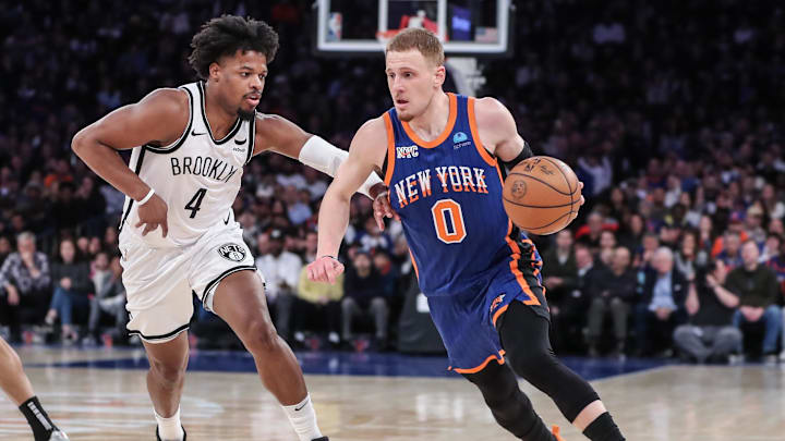 Mar 23, 2024; New York, New York, USA; New York Knicks guard Donte DiVincenzo (0) looks to drive past Brooklyn Nets guard Dennis Smith Jr. (4) in the fourth quarter at Madison Square Garden. Mandatory Credit: Wendell Cruz-Imagn Images Mar 23, 2024; New York, New York, USA; New York Knicks guard Donte DiVincenzo (0) looks to drive past Brooklyn Nets guard Dennis Smith Jr. (4) in the fourth quarter at Madison Square Garden. Mandatory Credit: Wendell Cruz-Imagn Images