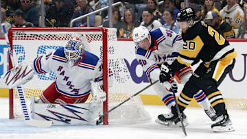 Oct 9, 2024; Pittsburgh, Pennsylvania, USA;  New York Rangers goaltender Igor Shesterkin (31) makes a save against Pittsburgh Penguins center Lars Eller (20) as New York defenseman Victor Mancini (90) defends during the first period at PPG Paints Arena. Mandatory Credit: Charles LeClaire-Imagn Images