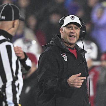 Dec 28, 2024; Annapolis, MD, USA;  North Carolina State Wolfpack head coach Dave Doeren reacts after a play during the first half of the Go Bowling Military Bowl at Navy-Marine Corps Memorial Stadium. Mandatory Credit: Tommy Gilligan-Imagn Images