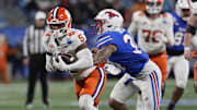 Dec 7, 2024; Charlotte, NC, USA; Clemson Tigers tight end Josh Sapp (5) is tackled by Southern Methodist Mustangs linebacker Ahmad Walker (34) during the third quarter in the 2024 ACC Championship game at Bank of America Stadium. Mandatory Credit: Jim Dedmon-Imagn Images