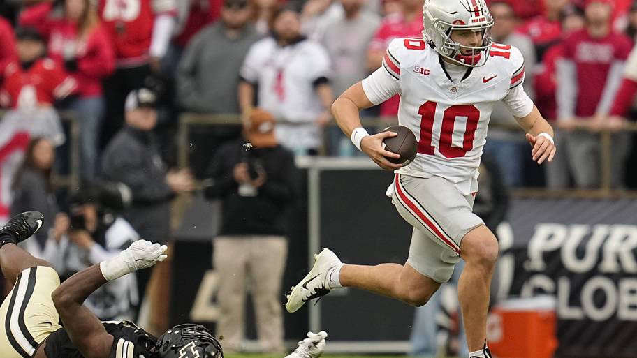 Ohio State quarterback Julian Sayin runs past Purdue defensive lineman CJ Nunnally.
