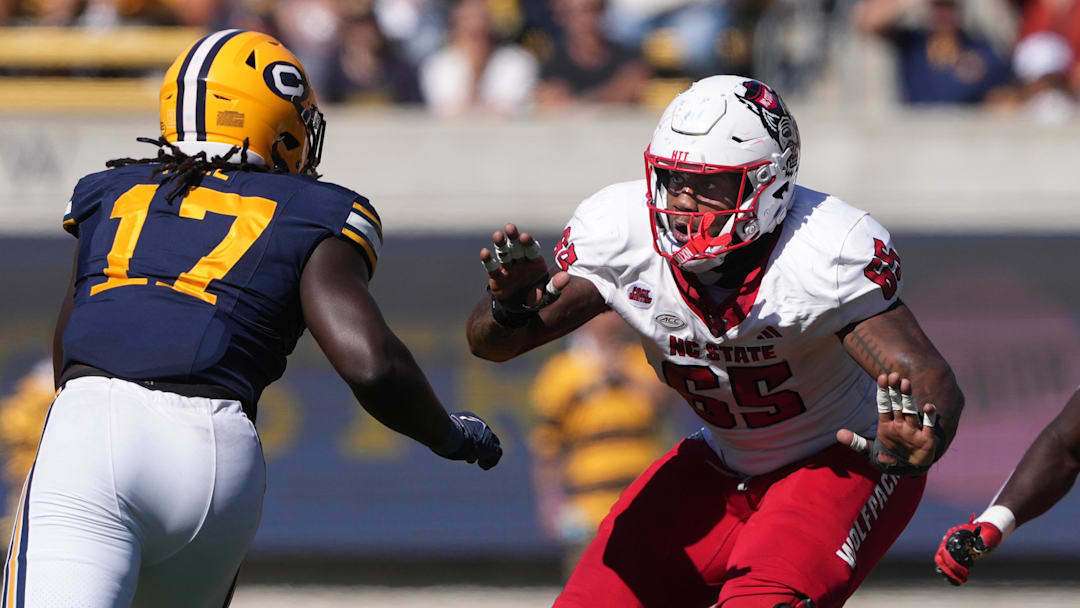 Oct 19, 2024; Berkeley, California, USA; North Carolina State Wolfpack offensive tackle Jacarrius Peak (65) blocks against California Golden Bears linebacker Cheikhsaliou Fall (17) during the second quarter at California Memorial Stadium. Mandatory Credit: Darren Yamashita-Imagn Images