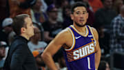 Nov 23, 2025; Phoenix, Arizona, USA: Phoenix Suns Head Coach Jordan Ott and Phoenix Suns guard Devin Booker (1) talk  in the first half of the game at Mortgage Match Up Center. Mandatory Credit: Arianna Grainey-Imagn Images