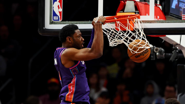 Jan 5, 2024; Phoenix, Arizona, USA; Phoenix Suns forward Chimezie Metu (4) dunks the ball against Miami Heat forward Nikola Jovic (5) during the third quarter at Footprint Center. Mandatory Credit: Mark J. Rebilas-USA TODAY Sports