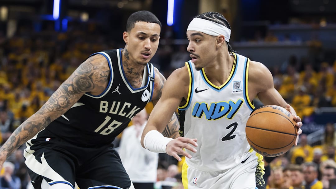 Indiana Pacers guard Andrew Nembhard dribbles the ball while Milwaukee Bucks forward Kyle Kuzma defends in the second half at Gainbridge Fieldhouse on Saturday.