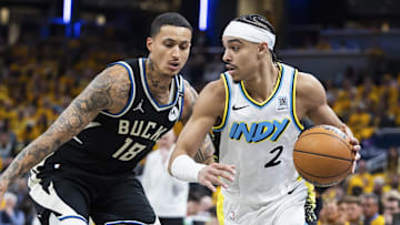Apr 19, 2025; Indianapolis, Indiana, USA;  Indiana Pacers guard Andrew Nembhard (2) dribbles the ball while Milwaukee Bucks forward Kyle Kuzma (18) defends in the second half at Gainbridge Fieldhouse. Mandatory Credit: Trevor Ruszkowski-Imagn Images
