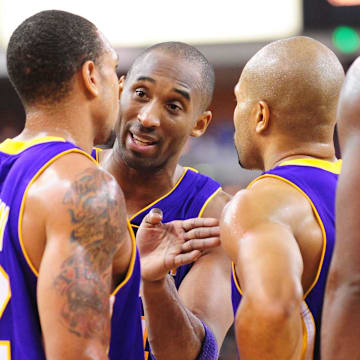 December 26, 2009; Sacramento, CA, USA; Los Angeles Lakers guard Kobe Bryant (center) instructs guard Shannon Brown (12) while guard Derek Fisher (right) looks on during the fourth quarter against the Sacramento Kings at Arco Arena. The Lakers defeated the Kings 112-103 in double overtime. Mandatory Credit: Kyle Terada-Imagn Images