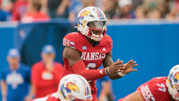 Aug 29, 2025; Lawrence, Kansas, USA; Kansas Jayhawks quarterback Jalon Daniels (6) behind takes the snap.