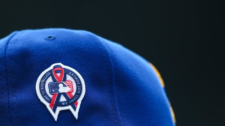 A patch remembering the September 11th terrorist attacks is seen on a Seattle Mariners hat during the game against the Atlanta Braves at T-Mobile Park. 