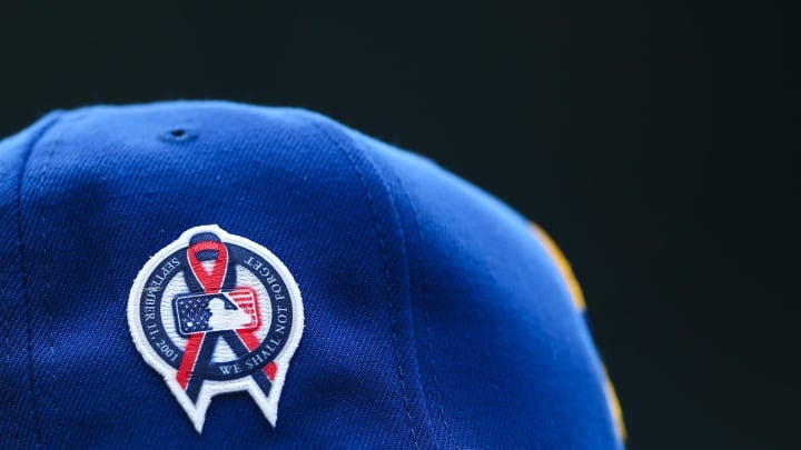 A patch remembering the September 11th terrorist attacks is seen on a Seattle Mariners hat during the game against the Atlanta Braves at T-Mobile Park in 2022.