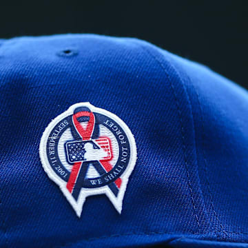 A patch remembering the September 11th terrorist attacks is seen on a Seattle Mariners hat during the game against the Atlanta Braves at T-Mobile Park in 2022.