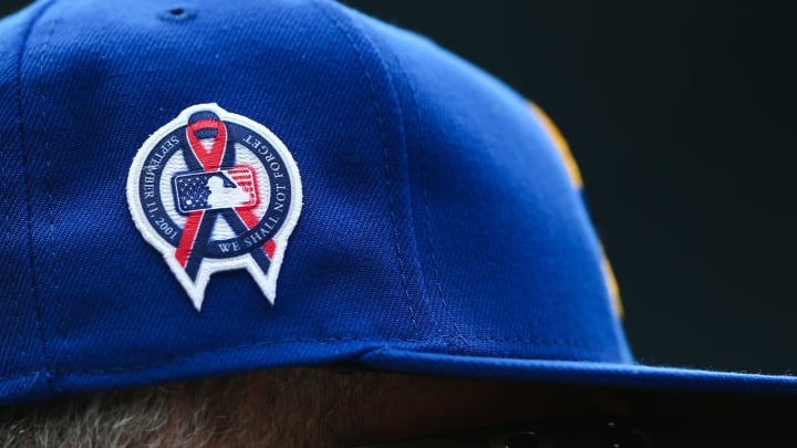 A patch remembering the September 11th terrorist attacks is seen on a Seattle Mariners hat during the game against the Atlanta Braves at T-Mobile Park in 2022.