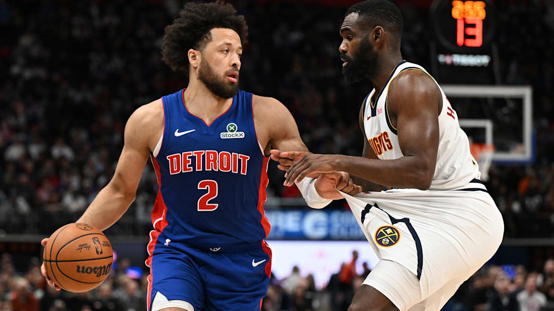 Feb 3, 2026; Detroit, Michigan, USA;  Detroit Pistons guard Cade Cunningham (2) tugs on the shorts of Denver Nuggets guard Tim Hardaway Jr. (10) before trying to drive past him in the second quarter at Little Caesars Arena. 