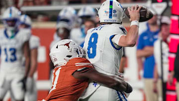 Texas Longhorns linebacker Colin Simmons (11) tries to sack Kentucky Wildcats quarterback Cutter Boley (8) in the fourth quarter during the second half of an NCAA college football game at Darrell K Royal Texas Memorial Stadium, Austin, Texas, Saturday, Nov 24, 2024.