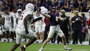 Sep 26, 2025; Charlottesville, Virginia, USA; Virginia Cavaliers quarterback Chandler Morris (4) passes the ball as Florida State Seminoles defensive lineman Darrell Jackson Jr. (6) chases in the first overtime period at Scott Stadium. Mandatory Credit: Geoff Burke-Imagn Images