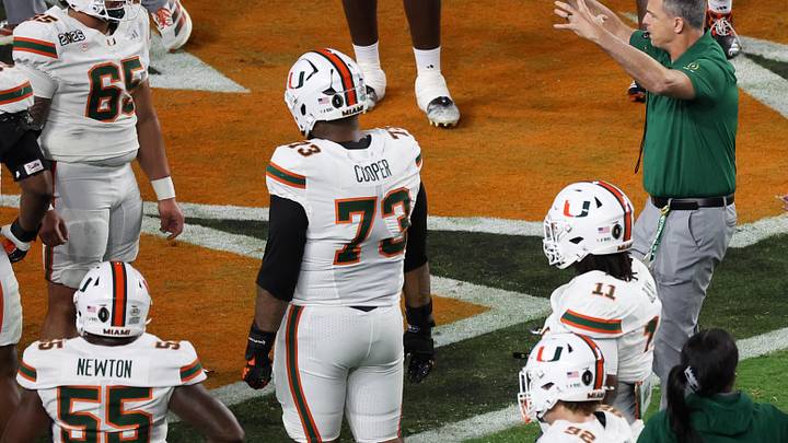 Jan 19, 2026; Miami Gardens, FL, USA; Miami Hurricanes head coach Mario Cristobal speaks to his players during warmups prior to the College Football Playoff National Championship game against the Indiana Hoosiers at Hard Rock Stadium. Mandatory Credit: Kim Klement Neitzel-Imagn Images