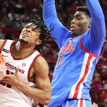 Arkansas Razorbacks guard D.J. Wagner (21) drives against Ole Miss Rebels forward Malik Dia (0) during the second half at Bud Walton Arena. Ole Miss won 73-66. 