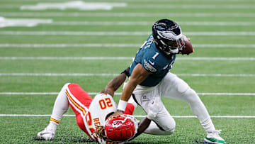 Feb 9, 2025; New Orleans, LA, USA; Philadelphia Eagles quarterback Jalen Hurts (1) runs with the ball against Kansas City Chiefs safety Justin Reid (20) during the first half of Super Bowl LIX at Caesars Superdome. Mandatory Credit: Bill Streicher-Imagn Images